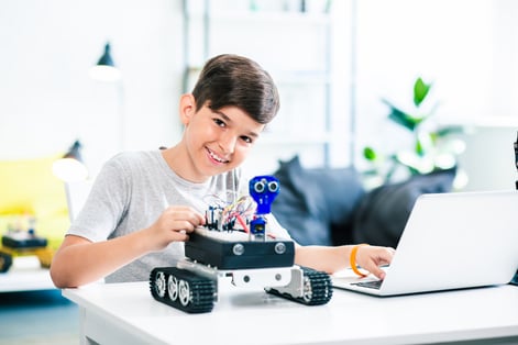 smart-positive-boy-testing-robot-while-getting-ready-engineering-classes-home